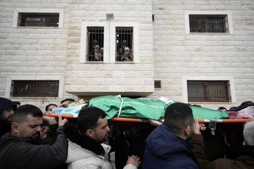 Palestinian mourners carry the body of Muhammad Jalamneh, draped in the Hamas militant group flag, during his funeral after he was killed in an Israeli military raid at Ibn Sina Hospital in the West Bank town of Jenin, Tuesday, Jan. 30, 2024. Armed Israeli undercover forces disguised as women and medical workers stormed the hospital on Tuesday, killing three Palestinian militants. The Palestinian Health Ministry condemned the incursion on a hospital, where the military said the militants were hi