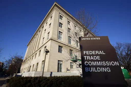 The Federal Trade Commission building is seen, Jan. 28, 2015, in Washington. U.S. companies would no longer be able to bar employees from taking jobs with competitors under a rule approved by the FTC on Tuesday, April 23, 2024, though the rule seems sure to be challenged in court. (AP Photo/Alex Brandon, File)
