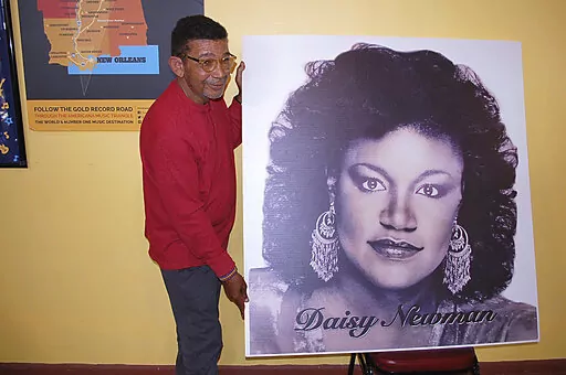 Bobby Dennis, executive director of the Natchez Museum of African American History and Culture holds a portrait of opera singer and music educator Daisy Cecelia Newman, who was born in the state and had an international performing career that included a nomination for a Tony award, Thursday, Dec. 30, 2021, in Natchez, Miss. Newman's portrait will be included in "The Black Butterfly," an exhibition about her life at the museum. (Roscoe Barnes III/The Natchez Democrat via AP)