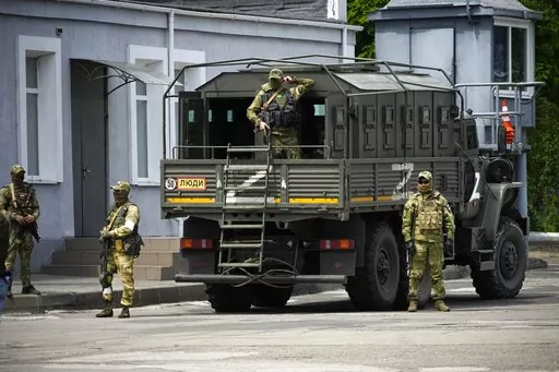 Russian soldiers guard an area as a group of foreign journalists visit in Kherson, Kherson region, south Ukraine, May 20, 2022. Russia’s military has announced that it’s withdrawing from Ukraine's southern city of Kherson and nearby areas. That would be another in a series of humiliating setbacks for Moscow’s forces in the 8-month-old war. This photo was taken during a trip organized by the Russian Ministry of Defense. (AP Photo, File)