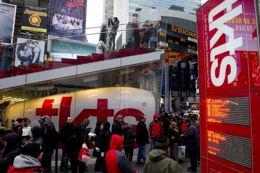 People wait in line at the Times Square TKTS discount ticket booth in New York on Jan. 19, 2012. The TKTS booth in Times Square, which has become part of the city's visual and financial DNA and a key part in keeping Broadway going, celebrates its 50th birthday this week. (AP Photo/Charles Sykes, File)