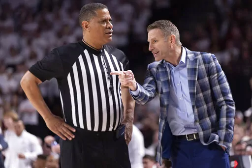 Alabama head coach Nate Oats talks to an official during the first half of an NCAA college basketball game against Texas A&M in College Station, Texas, Saturday, March 4, 2023. (Logan Hannigan-Downs/College Station Eagle via AP)