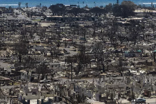 Charred remains of homes are visible following a wildfire in Lahaina, Hawaii, Aug. 22, 2023. The number of people still missing following wildfires that destroyed the historic community of Lahaina a month ago has dropped, Hawaii Gov. Josh Green said Friday, Sept. 8, 2023, while the number of confirmed deaths has remained at 115. (AP Photo/Jae C. Hong, File)