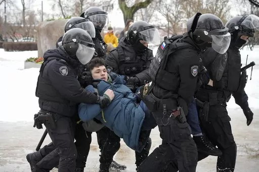 Police detain a man trying to lay flowers to honor Alexei Navalny at a monument in St. Petersburg, Russia, to victims of Soviet repression, on Saturday, Feb. 17, 2024. Over the last decade, Vladimir Putin's Russia evolved from a country that tolerates at least some dissent to one that ruthlessly suppresses it. Arrests, trials and long prison terms — once rare — are commonplace. (AP Photo, File)
