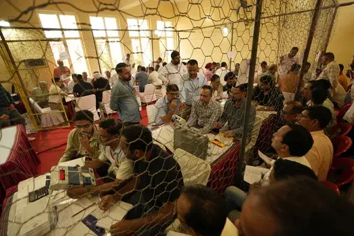 Election officers count votes for the recent election at a counting center in Jammu, India, Tuesday, Oct. 8, 2024. (AP Photo/Channi Anand)
