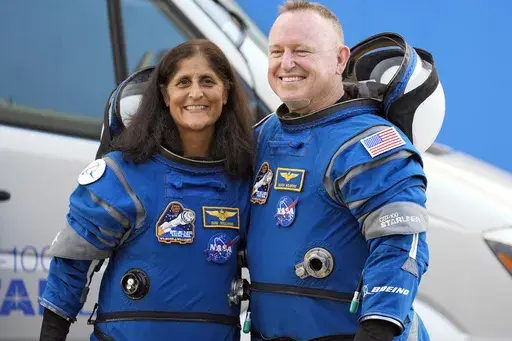 NASA astronauts Suni Williams, left, and Butch Wilmore stand together for a photo enroute to the launch pad at Space Launch Complex 41 Wednesday, June 5, 2024, in Cape Canaveral, Fla., for their liftoff on the Boeing Starliner capsule to the international space station. (AP Photo/Chris O'Meara, File)
