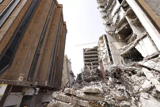 In this photo released by official website of the office of Iranian Senior Vice-President, on Friday, May 27, 2022, ruins of a tower at under construction 10-story Metropol Building remains after it collapsed on Monday, in the southwestern city of Abadan, Iran. Rescue teams at the site of the tower pulled five more bodies from the rubble on Friday, bringing the death toll in the disaster to 24. (Iranian Senior Vice-President Office via AP)