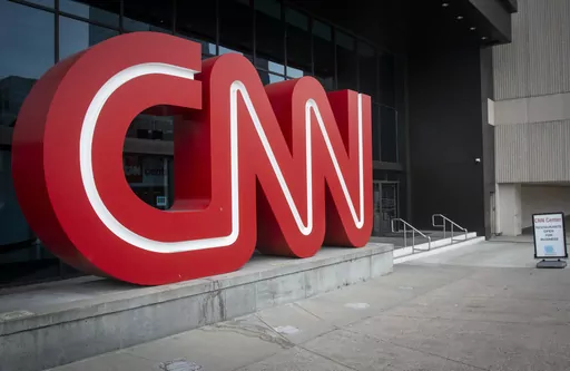 The CNN logo is displayed at the entrance to the CNN Center in Atlanta on Feb. 2, 2022. Cable news ratings are down across the board compared to 2022, when Russia's invasion of Ukraine was in the news. CNN's dip is most dramatic — 61% in prime-time in March. (AP Photo/Ron Harris, File)