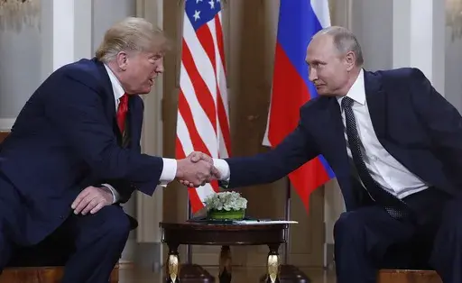 U.S. President Donald Trump, left, and Russian President Vladimir Putin, right, shake hands at the beginning of a meeting at the Presidential Palace in Helsinki, Finland, July 16, 2018. (AP Photo/Pablo Martinez Monsivais, File)