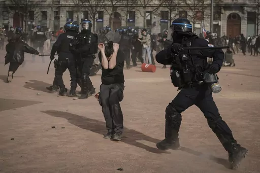 Police officers scuffle with protesters during a demonstration in Lyon, central France, on March 23, 2023. French authorities see the police as protectors ensuring that citizens can peacefully protest President Emmanuel Macron’s contentious retirement age increase. But to human rights advocates and demonstrators who were clubbed or tear-gassed, officers have overstepped their mission. (AP Photo/Laurent Cipriani, File)