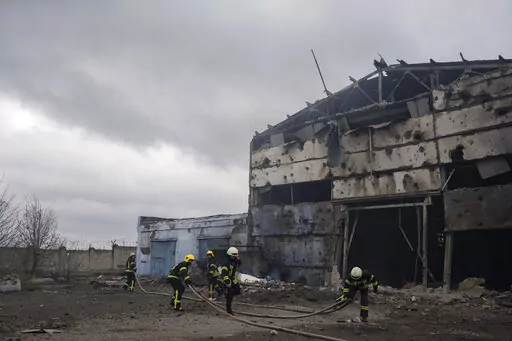 Firefighters try to extinguish the fire at a damaged factory following a Russian bombing in Kramatorsk, Ukraine, Thursday, April 14, 2022. (AP Photo/Petros Giannakouris)