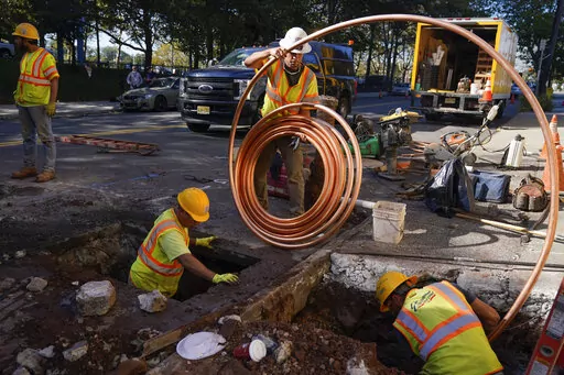 Workmen prepare to replace older water pipes with a new copper one in Newark, N.J., Thursday, Oct. 21, 2021. Lead pipes have caused harm for decades. In recent years, residents in Newark and Benton Harbor, Mich., were forced to use bottled water for basic needs like cooking and drinking, after tests revealed elevated levels of lead. (AP Photo/Seth Wenig, File)