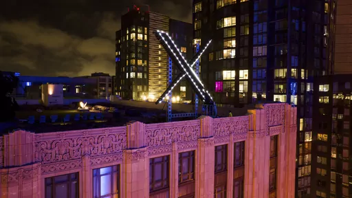 Workers install lighting on an "X" sign atop the company headquarters, formerly known as Twitter, in San Francisco, on July 28, 2023. The social media platform X says it is trying to take action on a flood of posts sharing graphic media, violent speech and hateful conduct about the latest war between Israel and Hamas. (AP Photo/Noah Berger, File)