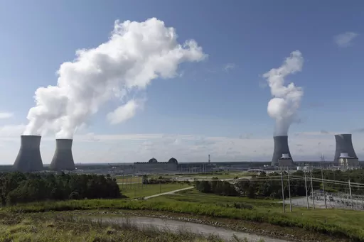 Nuclear reactors and cooling towers of the four units of Plant Vogtle, a nuclear plant near Waynesboro, Ga., are shown on July 31, 2023. Georgia Power Co. announced Thursday, Aug. 17, 2023, that Unit 4, at far right, is loading fuel, with the aim of sending power to the grid reliably by March 2024. Unit 4 and the now-operating Unit 3 and Unit 4 are the first new American reactors built from scratch in decades. (Arvin Temkar/Atlanta Journal-Constitution via AP, File)