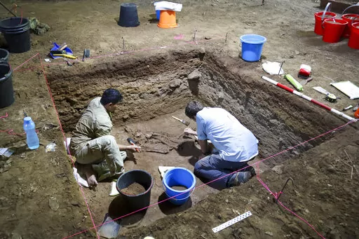 Dr Tim Maloney and Andika Priyatno work at the site in a cave in East Kalimantan, Borneo, Indonesia, March 2, 2020. The remains, which have been dated to 31,000 years old, mark the oldest evidence for amputation yet discovered. And the prehistoric “surgery” could show that humans were making medical advances much earlier than previously thought, according to the study published Wednesday, Sept. 7, 2022 in the journal Nature.(Tim Maloney/Griffith University via AP)