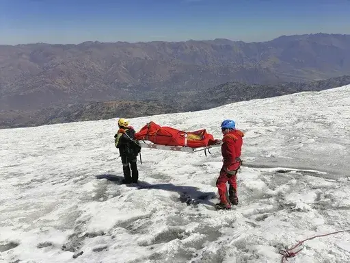This photo distributed by the Peruvian National Police shows police carrying a body that they identify as U.S. mountain climber William Stampfl, on Huascaran mountain in Huaraz, Peru, July 5, 2024. Peruvian authorities announced on Tuesday, July 9, 2024, that they have found the mummified body of the American man who died 22 years ago, along with two other American climbers, after the three were trapped in an avalanche while trying to climb Peru's highest mountain. (Peruvian National Police via 