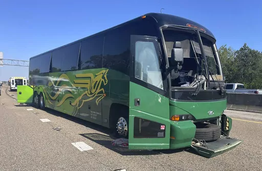 In this photo provided by the Mississippi Highway Patrol, a bus sits on Interstate 10 after blowing a tire and hitting a concrete barrier, near Bay St. Louis, Miss., Friday, April 5, 2024. The bus was transporting University of South Carolina students and their guests to an event. (Master Sgt. Cal Robertson/Mississippi Highway Patrol via AP)