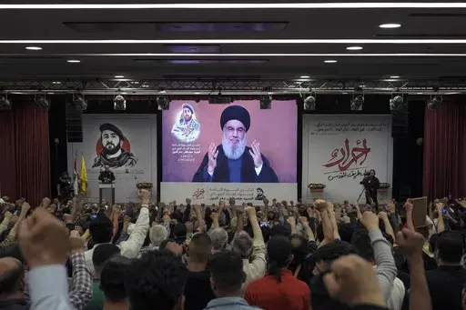 Supporters of the Iranian-backed Hezbollah group listen to a speech by Hezbollah leader Sayyed Hassan Nasrallah speaking via a video link, in the southern suburbs of Beirut, Lebanon, Tuesday, May 14, 2024. Israel and the Lebanese militant group Hezbollah have recently ratcheted up their threats of an all-out war. Hezbollah leader Hassan Nasrallah warned Israel last week that if it launches an offensive in Lebanon, his group has new weapons and capabilities it can use against Israeli forces and c