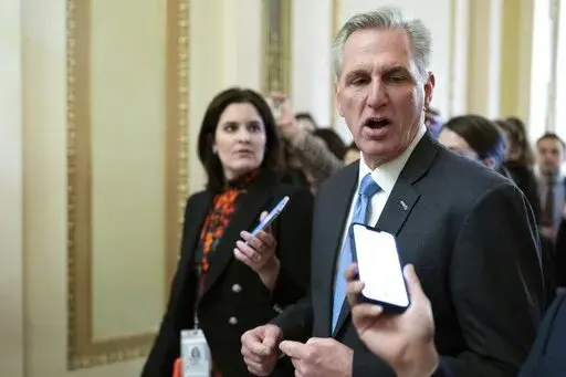 Speaker of the House Kevin McCarthy, R-Calif., talks to reporters as he walks to the House chamber at the Capitol in Washington, Monday, Jan. 9, 2023. (AP Photo/Jose Luis Magana)