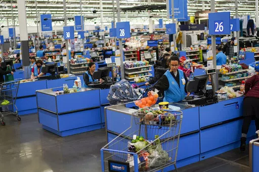Cashiers process purchases at a Walmart Supercenter in North Bergen, N.J., on Feb. 9, 2023. Retailers, including Walmart and Target, are stepping up discounting heading into the summer of 2024, as they hope to offer frustrated shoppers some relief from higher prices and entice them to open their wallets.(AP Photo/Eduardo Munoz Alvarez, File)