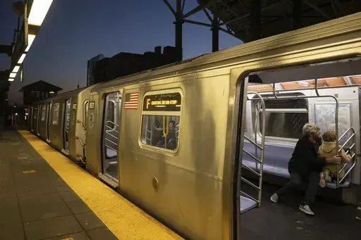 Commuters sit on the F train at the Coney Island-Stillwell Avenue Station, Thursday, Dec. 26, 2024, in New York. (AP Photo/Yuki Iwamura)