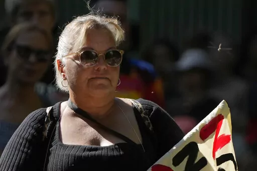 A dragonfly buzzes past a woman attending an Invasion Day rally in Sydney, Thursday, Jan. 26, 2023. Australia is marking the anniversary of British colonists settling modern day Sydney in 1788 while Indigenous protesters deride Australia Day as Invasion Day. (AP Photo/Rick Rycroft)