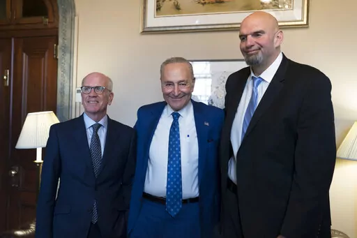 Senate Majority Leader Chuck Schumer, D-N.Y., center, welcomes Senator-elect Peter Welch, D-Vt., left, and Senator-elect John Fetterman, D-Pa., whose victories helped give Democrats the majority in the next Congress, at the Capitol in Washington, Tuesday, Nov. 15, 2022. (AP Photo/J. Scott Applewhite, File)