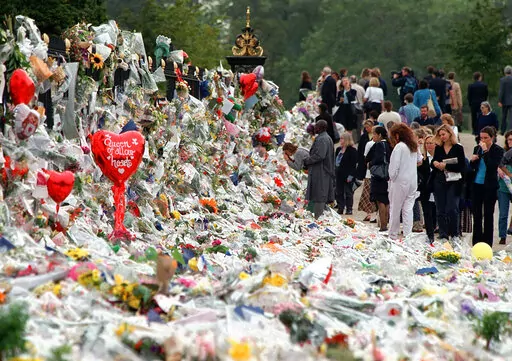 Mourners file past the tributes left in memory of Diana Princess of Wales at Kensington Palace in London, Friday, Sept. 5, 1997. It was a warm Saturday evening and journalists had gathered at a Paris restaurant to enjoy the last weekend of summer. At sometime past midnight, phones around the table began to ring all at once. News desks were contacting reporters and photographers to alert them that Princess Diana’s car had crashed in the Pont de l’Alma tunnel in Paris. That's how the news unfo