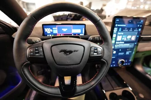 The cockpit of a Ford Mustang Mach-E electric car is pictured at the Motor Show in Essen, Germany, Thursday, Dec. 2, 2021 (AP Photo/Martin Meissner)