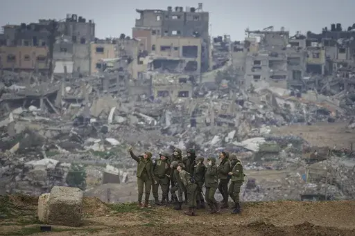 Female Israeli soldiers pose for a photo in southern Israel, on the border of the Gaza Strip, on Feb. 19, 2024. (AP Photo/Tsafrir Abayov)