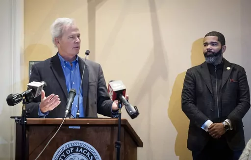 Ted Henifin, left, the City of Jackson water system third-party administrator, addresses media questions during a news conference at City Hall as Jackson Mayor Chokwe Antar Lumumba listens on Dec. 5, 2022, in Jackson, Miss. Henifin, the manager appointed by the U.S. Department of Justice to oversee reforms to the beleaguered water system in Mississippi’s capital city, says he won't have enough money to cover expenses until more federal funds arrive. (Barbara Gauntt/The Clarion-Ledger via AP, F