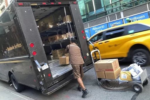 A United Parcel Service driver loads his truck, adjacent to a UPS Store, in New York, Thursday, May 11, 2023. Frustrated by what he called an "appalling counterproposal" earlier this week, the head of the union representing 340,000 UPS workers said a strike now appears inevitable and gave the shipping giant a Friday deadline to improve its offer. (AP Photo/Richard Drew, File)