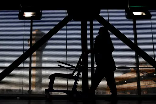 An airline employee transfers a wheelchair to her station at O'Hare International Airport in Chicago, Nov. 23, 2022. The Biden administration will propose Thursday, Feb. 29, 2024, to make it easier for the government to fine airlines for damaging or misplacing wheelchairs by making it an automatic violation of a federal law on accessible air travel. (AP Photo/Nam Y. Huh, File)