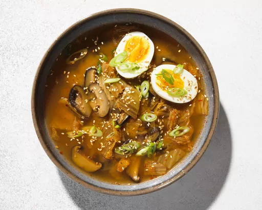 This image released by Milk Street shows a recipe for Miso, Shiitake Mushroom and Kimchi Soup. (Milk Street via AP)
