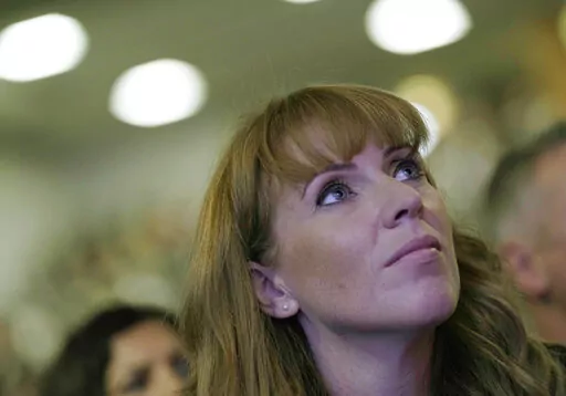 Labour deputy leader Angela Rayner watches as the leader of the British Labour Party Keir Starmer makes his keynote speech at the annual party conference in Brighton, England, Wednesday, Sept. 29, 2021.  Women from across British politics called Monday, April 25, 2022 for action to tackle misogyny after a newspaper ran a story accusing the deputy opposition leader of trying to “distract” the prime minister during debates by crossing and uncrossing her legs. (AP Photo/Alastair Grant, File)