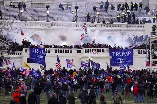 Violent protesters, loyal to President Donald Trump, storm the Capitol, Wednesday, Jan. 6, 2021, in Washington. The House committee investigating the Jan. 6 insurrection poked another hole in the pro-Trump conspiracy theory that federal agents orchestrated the attack, confirming on Tuesday, Jan. 11, 2022, that a man at the center of the claims said he’d never been an FBI informant. (AP Photo/John Minchillo, File)