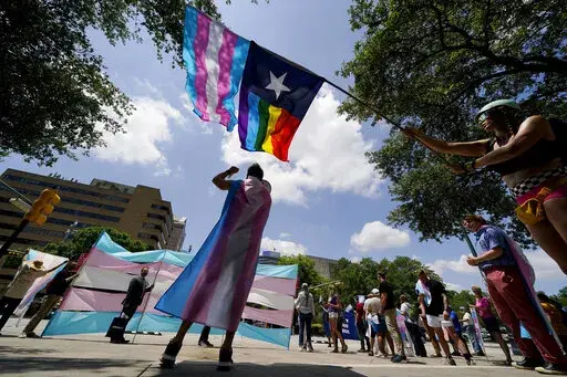 Demonstrators gather on the steps to the State Capitol to speak against transgender-related legislation bills being considered in the Texas Senate and Texas House, May 20, 2021, in Austin, Texas. A Texas judge on Friday, June 10, 2022, temporarily blocked the state from investigating families of transgender children who have received gender-confirming medical care, a new obstacle to the state labeling such treatments as child abuse. (AP Photo/Eric Gay, File)