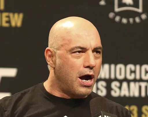 Joe Rogan is seen during a weigh-in before UFC 211 on Friday, May 12, 2017, in Dallas. Spotify has penned a new multi-year partnership deal with Rogan, Friday, Feb. 2, 2024. The enormously popular show will soon also be available on competing platforms, including YouTube and Apple Podcasts. ( AP Photo/Gregory Payan, File)