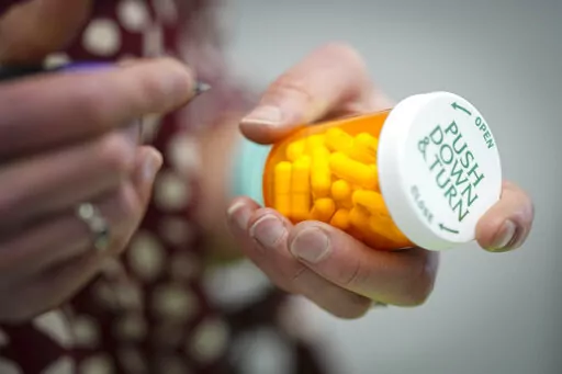 Jessi Stout, owner of the Table Rock Pharmacy fills a prescription on Friday, Jan. 6, 2023, in Morganton, N.C. Drugstore chains are still trying to find enough employees to put a stop to temporary pharmacy closures. (AP Photo/Chris Carlson)