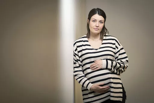 Jillaine St.Michel stands for a portrait in Boise, Idaho on Saturday, Dec. 2, 2023. A year earlier, she learned that her previous 20-week fetus had multiple genetic and developmental problems and probably wouldn’t survive. She lives in Idaho, which has a ban on abortions, so St.Michel and her husband called about 15 out-of-state clinics, finally getting on a three-week waiting list in Denver and a two-week waiting list in Seattle. Pregnant again, she is due to give birth to a boy in January. (