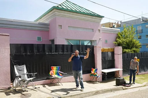 A couple of abortion opponents stand outside the Jackson Women's Health Organization clinic and call out to the patients inside the medical facility, encouraging them to not have an abortion, Jackson, Miss., Saturday, June 25, 2022. The clinic is the only facility that performs abortions in the state. However, on Friday, the U.S. Supreme Court overturned Roe v. Wade, ending constitutional protections for abortion. (AP Photo/Rogelio V. Solis)