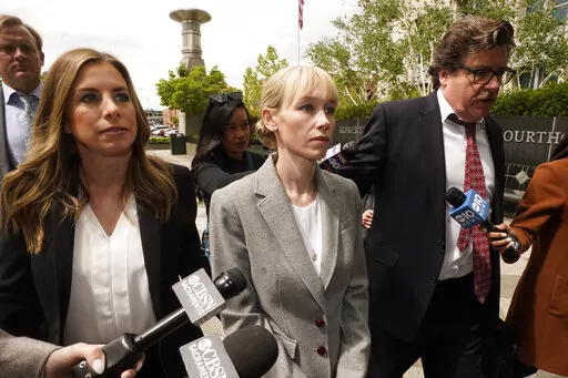 Sherri Papini of Redding leaves the federal courthouse accompanied by her attorney, William Portanova, right, in Sacramento, Calif., April 13, 2022. During a virtual hearing Papini accepted a plea bargain with prosecutors and pleaded guilty, Monday, April 18, 2022, to a single count of mail fraud and one count of making false statements. She will be sentenced on July 11, 2022. (AP Photo/Rich Pedroncelli, File)