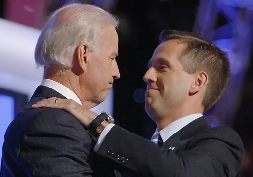 Then-Democratic vice presidential candidate Sen. Joe Biden, D-Del., left, embraces his son Beau Biden on stage at the Democratic National Convention in Denver, Aug. 27, 2008. (AP Photo/Charles Dharapak, File)