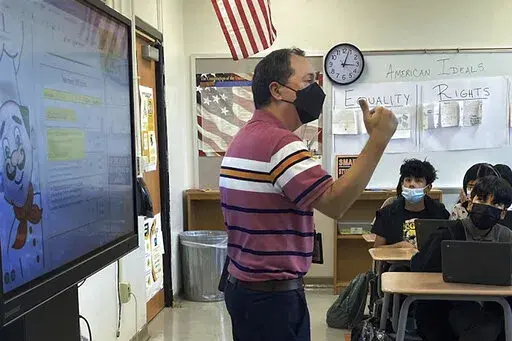 This photo shows Daniel Santos, a middle school history teacher during class, in Houston, in November, 2021. Teachers around the U.S. are confronting classrooms where as many as half of students are absent. That's because they have been exposed to COVID-19 or their families kept them at home out of concern about the surging coronavirus. F  (Courtesy Daniel Santos via AP)