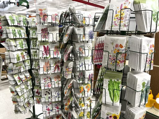 This Jan. 23, 2022 image provided by Jeff Lowenfels shows seed packets for sale on in Anchorage, Alaska. Seed racks are back in stores promising all kinds of abundance in the gardening season ahead. Be careful approaching them, those seed packets can lure you in with pretty pictures on the front. But it's the advice on the back you need to follow. (Jeff Lowenfels via AP)