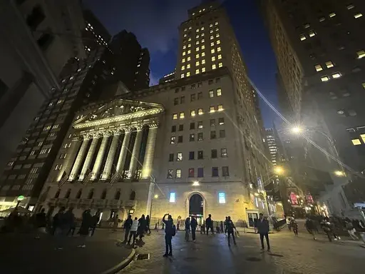 People walk past the New York Stock Exchange on Tuesday, Nov. 26 2024. (AP Photo/Peter Morgan, File)