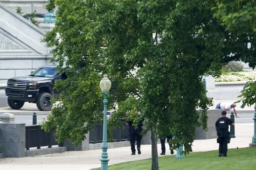A man is apprehended after being in a pickup truck parked on the sidewalk in front of the Library of Congress' Thomas Jefferson Building, as seen from a window of the U.S. Capitol, Aug. 19, 2021, in Washington. A man who caused evacuations and an hourslong standoff with police on Capitol Hill when he claimed he had a bomb in his pickup truck outside the Library of Congress pleaded guilty on Friday, Jan. 27, 2023, to a charge of threatening to use an explosive. Floyd Ray Roseberry faces up to 10 