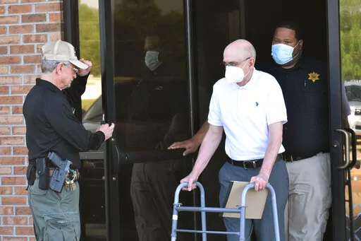 Paul West, center, is escorted by deputies from the Leflore County Civic Center in Greenwood, Miss., on Wednesday, April 13, 2022, after a jury found him guilty of sexually abusing a student at St. Francis of Assisi School in the 1990s. West, a former Franciscan friar, worked as a teacher and then principal at the Catholic school in Greenwood. Circuit Judge Ashley Hines sentenced West to 30 years on the first count and 15 years on the second. (Tim Kalich/The Commonwealth via AP)