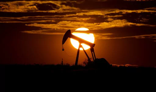 The sun sets behind an idle pump jack near Karnes City, USA, April 8, 2020. Oil prices are sagging amid fears of recessions across the globe. OPEC and allied countries are weighing what to do about that when they meet online Thursday, Sept. 8, 2022. High oil prices were a bonanza for countries like Saudi Arabia over the summer, but now they're well off those highs. Saudi Arabia's oil minister has even said the group known as OPEC+ could cut production at any time. (AP Photo/Eric Gay, File)