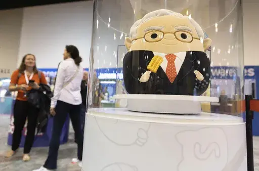 The Squishmallows booth sells toys modeled after Warren Buffett, pictured, and Charlie Munger in the exhibit hall for the Berkshire Hathaway annual meeting, Saturday, May 6, 2023, in Omaha, Neb. (AP Photo/Rebecca S. Gratz, File)